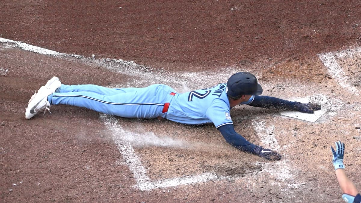 Toronto Blue Jays shortstop Ernie Clement (22) scores a run against the Detroit Tigers in the sixth inning at Rogers Centre.