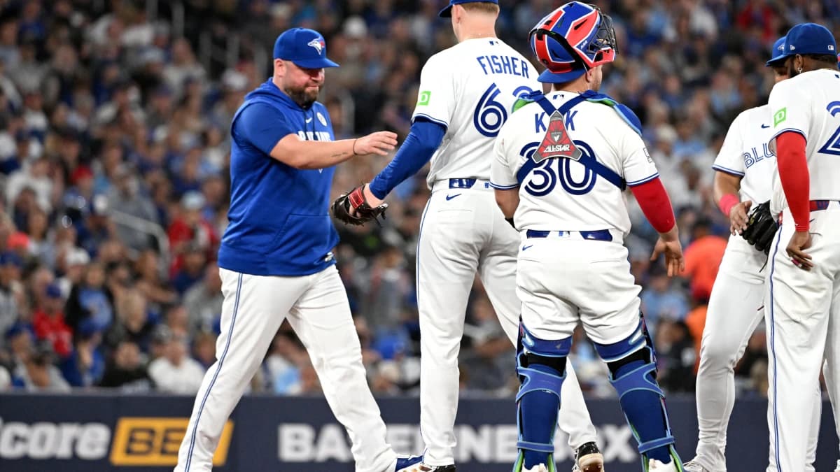 Toronto Blue Jays manager John Schneider (14) relieves starting pitcher Braydon Fisher (63) in the second inning at Rogers Centre.