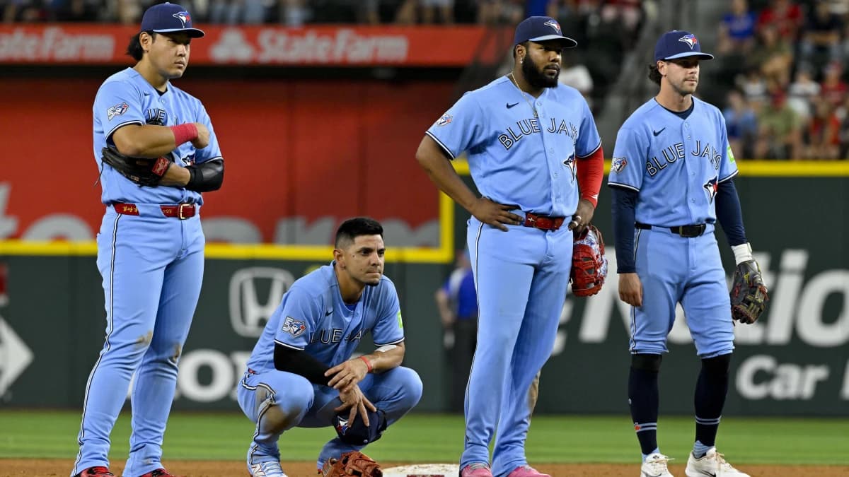 Toronto Blue Jays third baseman Kazuma Okamoto (7) and shortstop Andres Gimenez (0) and first baseman Vladimir Guerrero Jr. (27) and third baseman Ernie Clement (22) look on during the sixth inning against the Texas Rangers at Globe Life Field.