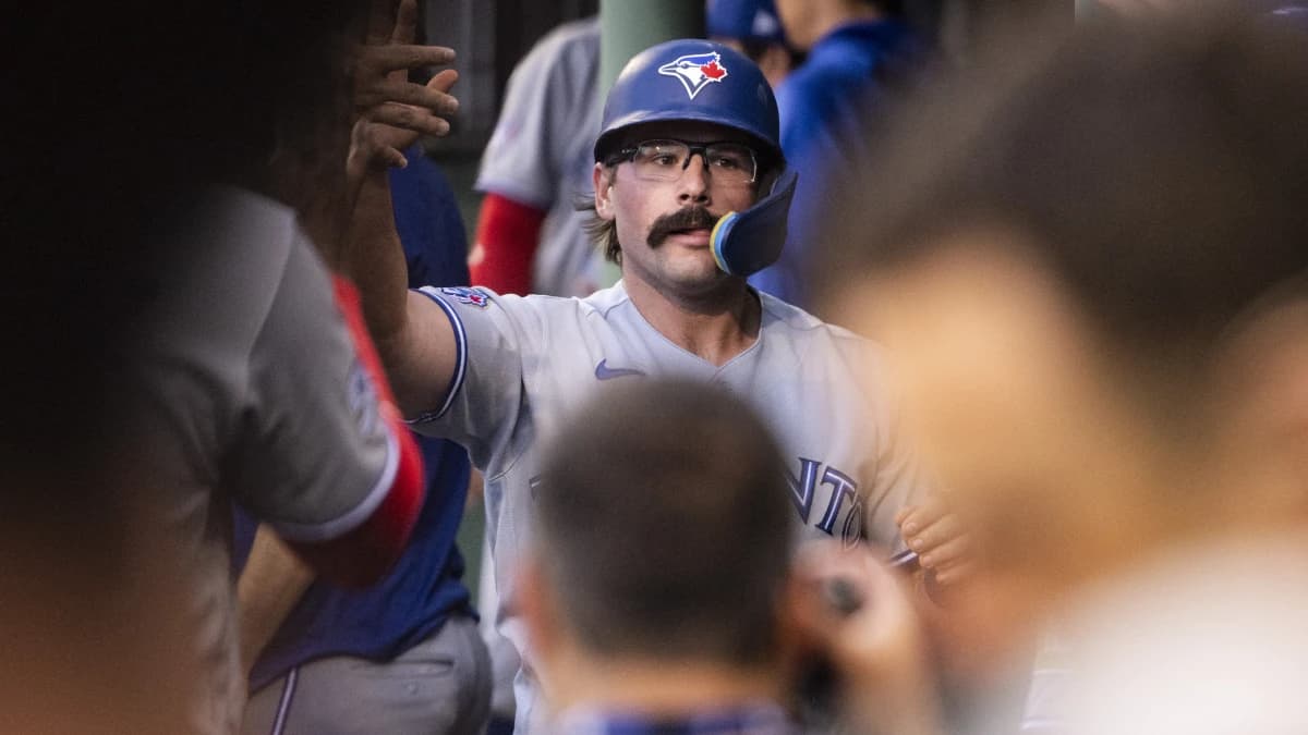 Toronto Blue Jays left fielder Davis Schneider (36) is greeted in the dugout after scoring off a single hit by shortstop Andrés Giménez (0), not pictured, in the third inning against the Boston Red Sox at Fenway Park.