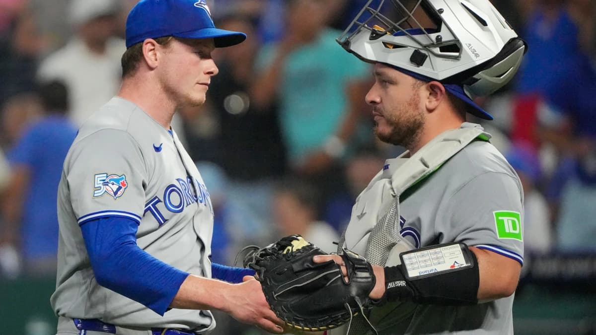 Toronto Blue Jays pitcher Louis Varland (77) celebrates with catcher Alejandro Kirk (30) after the win over the Kansas City Royals at Kauffman Stadium.
