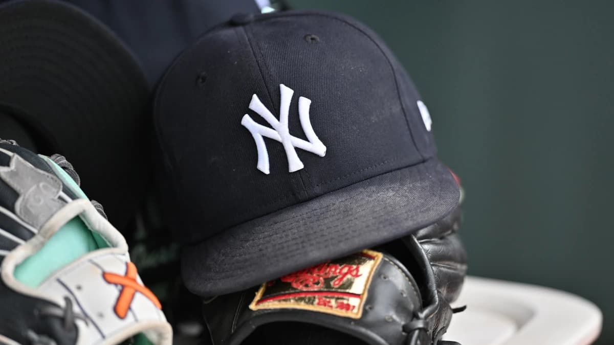 A detail view of a New York Yankees baseball hat and a glove during the eighth inning against the Chicago Cubs at Wrigley Field