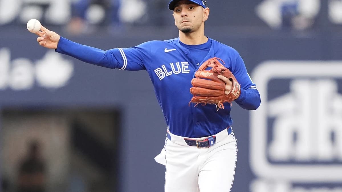Toronto Blue Jays shortstop Andres Gimenez (0) throws out Cincinnati Reds first baseman Sal Stewart (not pictured) at first base during the ninth inning at Rogers Centre.