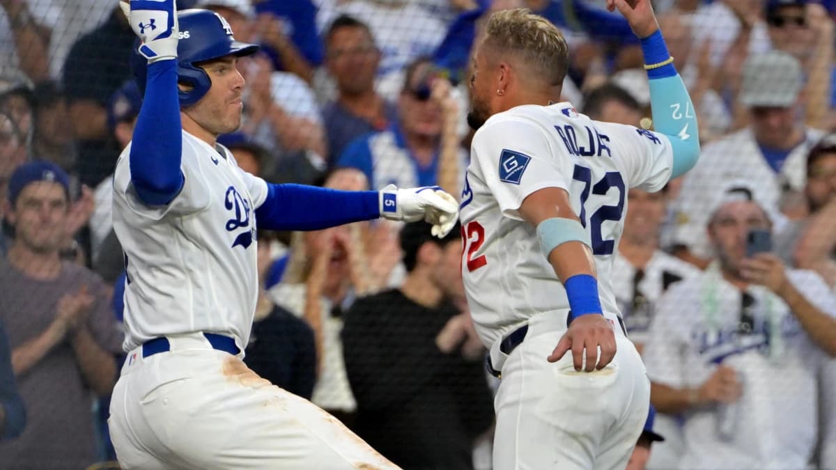 Los Angeles Dodgers first baseman Freddie Freeman (5) celebrates with second baseman Miguel Rojas (72) after hitting a home run during the fourth inning against the Atlanta Braves in game two of the NLDS for the 2026 MLB Playoffs at Uniqlo Field at Dodger Stadium.
