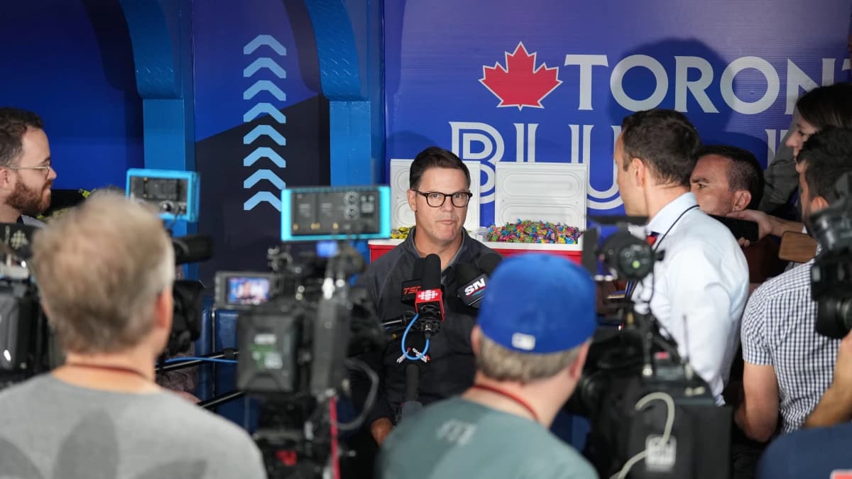 Toronto Blue Jays general manager Ross Atkins talks to the media during batting practice before a game against the Minnesota Twins at Rogers Centre.