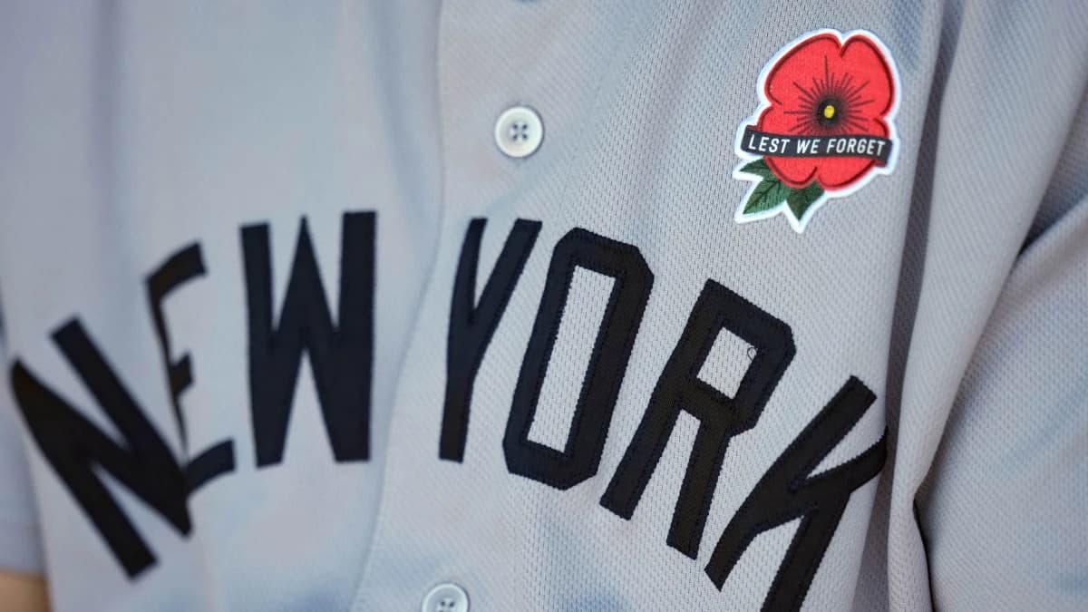 A detailed view of the a red poppy flower patch on the jersey worn by New York Yankees left fielder Cody Bellinger (35) in honor of Memorial Day prior to a game against the Kansas City Royals at Kauffman Stadium.