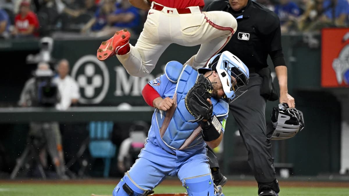 Texas Rangers left fielder Wyatt Langford (36) collides with Toronto Blue Jays catcher Alejandro Kirk (30) and scores a run during the sixth inning at Globe Life Field
