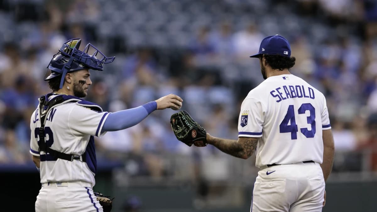 Kansas City Royals catcher Carter Jensen (22) hands the ball to Kansas City Royals pitcher Connor Seabold (43) during the fifth inning against the Tampa Bay Rays at Kauffman Stadium.