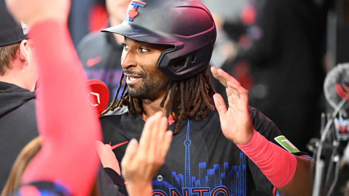 Toronto Blue Jays second baseman Charles McAdoo (26) celebrates with teammates in the dugout after scoring a run against the Cincinnati Reds in the first inning at Rogers Centre.