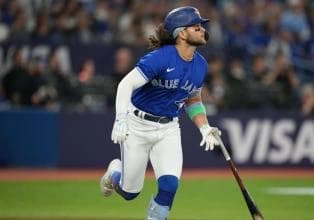 Bichette watches his hit as he heads for first base.