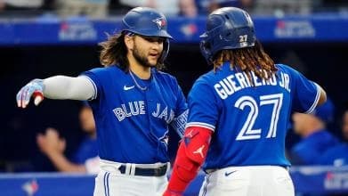 Vlad Guerrero Jr. and Bo Bichette celebrating a run scored..