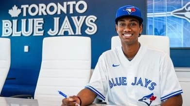 Arjun Nimmala sighing his rookie contract with he Toronto Blue Jays.