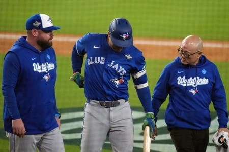 Toronto Blue Jays right fielder George Springer (4) leaves the game after an apparent injury in the seventh inning against the Los Angeles Dodgers during game three of the 2025 MLB World Series at Dodger Stadium.
