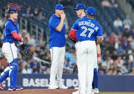 Toronto Blue Jays pitching coach Pete Walker (41) talks with starting pitcher Easton Lucas (62) against the Atlanta Braves during the fifth inning at Rogers Centre.
