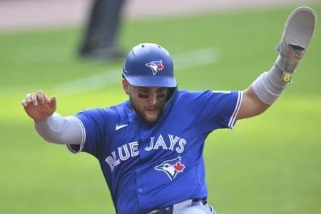 Toronto Blue Jays shortstop Bo Bichette (11) scores in the first inning against the Cleveland Guardians at Progressive Field.