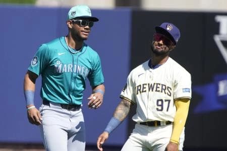 Seattle Mariners center fielder Julio Rodriguez (44) and Milwaukee Brewers right fielder Hedbert Perez (97) joke around before a game at American Family Fields of Phoenix.