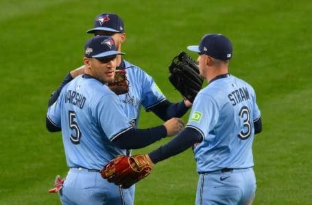 Toronto Blue Jays right fielder Nathan Lukes (38), center fielder Daulton Varsho (5) and center fielder Myles Straw (3) celebrate after winning game four of the ALCS round for the 2025 MLB playoffs against the Seattle Mariners at T-Mobile Park.