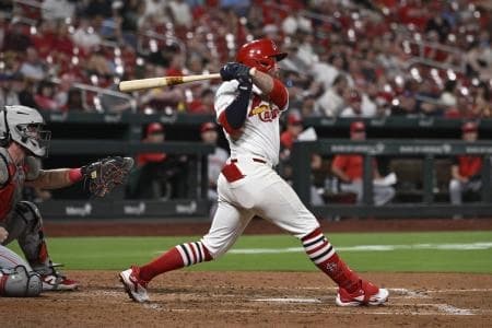 St. Louis Cardinals second baseman Brendan Donovan (21) hits a single against the Cincinnati Reds in the sixth inning at Busch Stadium.