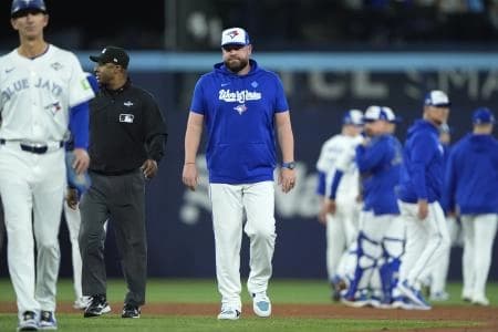 Toronto Blue Jays manager John Schneider (14) reacts after the benches clear in the fourth inning against the Los Angeles Dodgers during game seven of the 2025 MLB World Series at Rogers Centre.