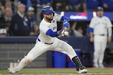 Toronto Blue Jays second baseman Isiah Kiner-Falefa (7) bunts against the Los Angeles Dodgers in the eleventh inning during game seven of the 2025 MLB World Series at Rogers Centre.