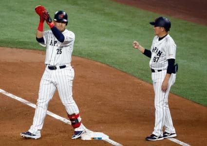 Japan first baseman Kazuma Okamoto (25) singles against the USA in the second inning at LoanDepot Park.