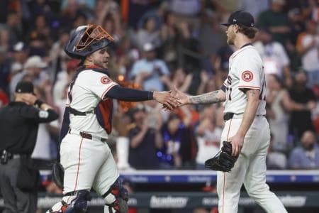 Houston Astros catcher Yainer Diaz (21) and relief pitcher Josh Hader (71) celebrate after the game against the Washington Nationals at Daikin Park.