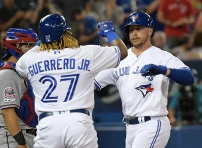 Toronto Blue Jays designated hitter Justin Smoak (14) is greeted at home plate by third baseman Vladimir Guerrero Jr. (27) after hitting a two run home run against Texas Rangers in the third inning at Rogers Centre