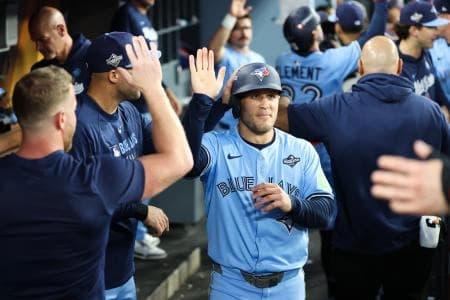 Toronto Blue Jays center fielder Daulton Varsho (5) celebrates in the dugout after scoring during the fourth inning against the Los Angeles Dodgers during game five of the 2025 MLB World Series at Dodger Stadium