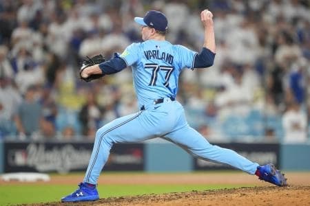 Toronto Blue Jays pitcher Louis Varland (77) pitches against the Los Angeles Dodgers in the ninth inning during game four of the 2025 MLB World Series at Dodger Stadium.