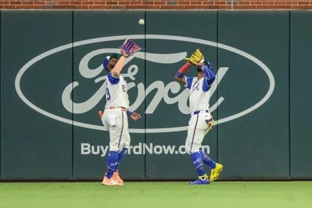 Atlanta Braves outfielder Michael Harris II (23) and outfielder Ronald Acuna Jr. (13) run to catch the fly ball for an out against the Pittsburgh Pirates during the eighth inning at Truist Park.