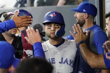 Toronto Blue Jays shortstop Bo Bichette (11) gets congratulated after hitting a two run home run against the Philadelphia Phillies during the second inning at Rogers Centre.