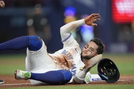 Toronto Blue Jays shortstop Bo Bichette (11) loses his helmet after getting caught trying to steal third base against Boston Red Sox third baseman Alex Bregman (not pictured) during the first inning at Rogers Centre.