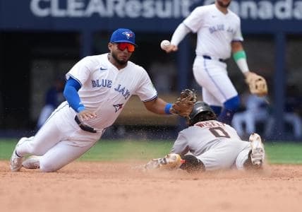 San Francisco Giants second baseman Brett Wisely (0) slides into second base ahead of the tag from Toronto Blue Jays shortstop Leo Jimenez (49) during the fifth inning at Rogers Centre.