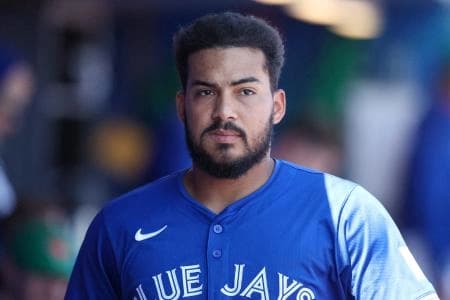 Toronto Blue Jays outfielder Anthony Santander (25) looks on from the dugout against the New York Yankees in the fourth inning during spring training at TD Ballpark