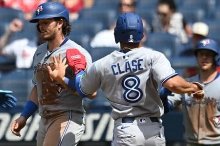 Toronto Blue Jays left fielder Jonatan Clase (8) celebrates with third baseman Addison Barger (47) after scoring during the ninth inning against the Cleveland Guardians at Progressive Field.