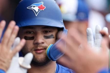 Toronto Blue Jays shortstop Bo Bichette (11) is congratulated after hitting a home run against the Houston Astros in the third inning during spring training at TD Ballpark.