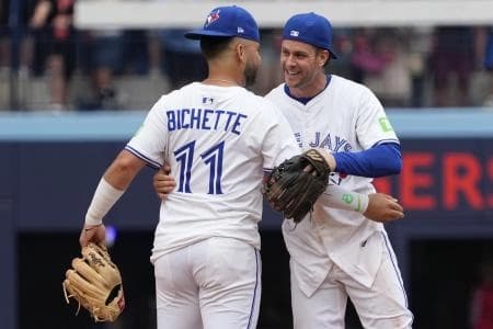Toronto Blue Jays second baseman Ernie Clement (22) and shortstop Bo Bichette (11) celebrate a win over the San Francisco Giants at Rogers Centre.