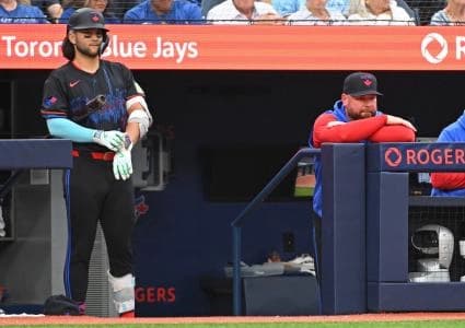 Toronto Blue Jays short stop Bo Bichette (11) and Manager John Schneider (14) in the dugout in the fourth inning against the Houston Astros at Rogers Centre.