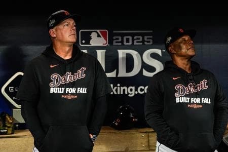 Detroit Tigers manager A.J. Hinch, left, and major league coach Gary Jones watch Seattle Mariners pregame ceremony from the dugout during ALDS Game 5 at T-Mobile Park in Seattle on Friday, Oct. 10, 2025.