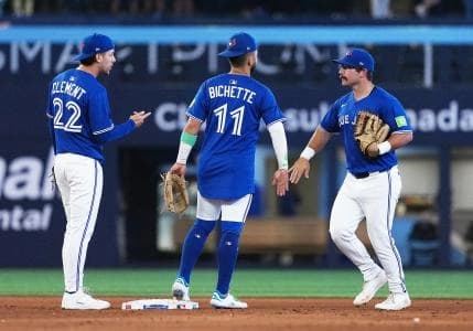 Toronto Blue Jays shortstop Bo Bichette (11) celebrates the win with Toronto Blue Jays left ielder Davis Schneider (36) against the Minnesota Twins at the end of the ninth inning at Rogers Centre.