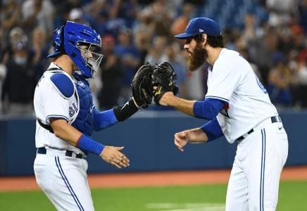 Toronto Blue Jays relief pitcher Jordan Romano (right) celebrates with catcher Reese McGuire (left) after defeating the Cleveland Indians at Rogers Centre