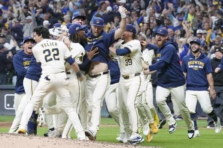 Milwaukee Brewers left fielder Christian Yelich (22) and pitcher Abner Uribe (45) and pitcher Trevor Megill (29) and pitcher Chad Patrick (39) and teammates celebrate after defeating the Chicago Cubs during game five of the NLDS round for the 2025 MLB playoffs at American Family Field.