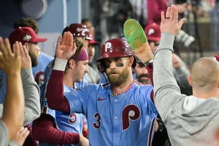 Philadelphia Phillies first baseman Bryce Harper (3) celebrates in the dugout after scoring on a Los Angeles Dodgers throwing error during the fourth inning during game three of the NLDS round for the 2025 MLB playoffs at Dodger Stadium.