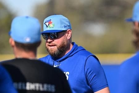 Toronto Blue Jays manager John Schneider (14) talks to a group of players during spring training at the Bobby Mattick Training Center at Englebert Complex.