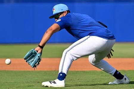 Toronto Blue Jays infielder Leo Jimenez (49) fields a ground ball during spring training at Bobby Mattick Training Center at Englebert Complex.
