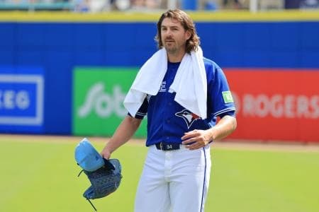 Toronto Blue Jays starting pitcher Kevin Gausman (34) walks to the dugout before the game against Team Canada at TD Ballpark