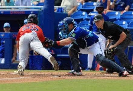 Boston Red Sox center fielder Braiden Ward (92) slides home as Toronto Blue Jays catcher Tyler Heineman (55) tags him out at home plate during the first inning at TD Ballpark.