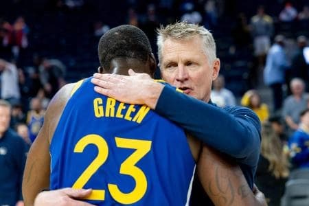 Golden State Warriors head coach Steve Kerr and Golden State Warriors forward Draymond Green (23) embrace after the game against the Chicago Bulls at Chase Center.