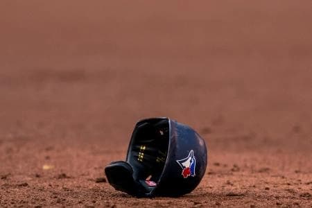 Toronto Blue Jays helmet lays on the infield at an MLB game against the Cleveland Indians at Rogers Centre.