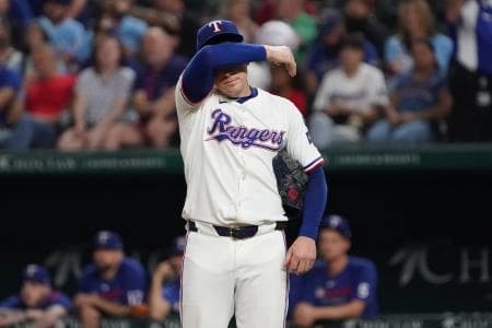 Texas Rangers pitcher Patrick Corbin (46) whips his brow between pitches during the second inning against the Minnesota Twins at Globe Life Field.